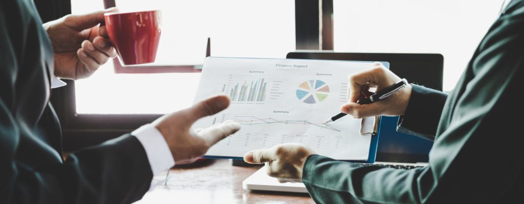 Business team analyzing income charts and graphs. Close up. Business analysis and strategy concept.
